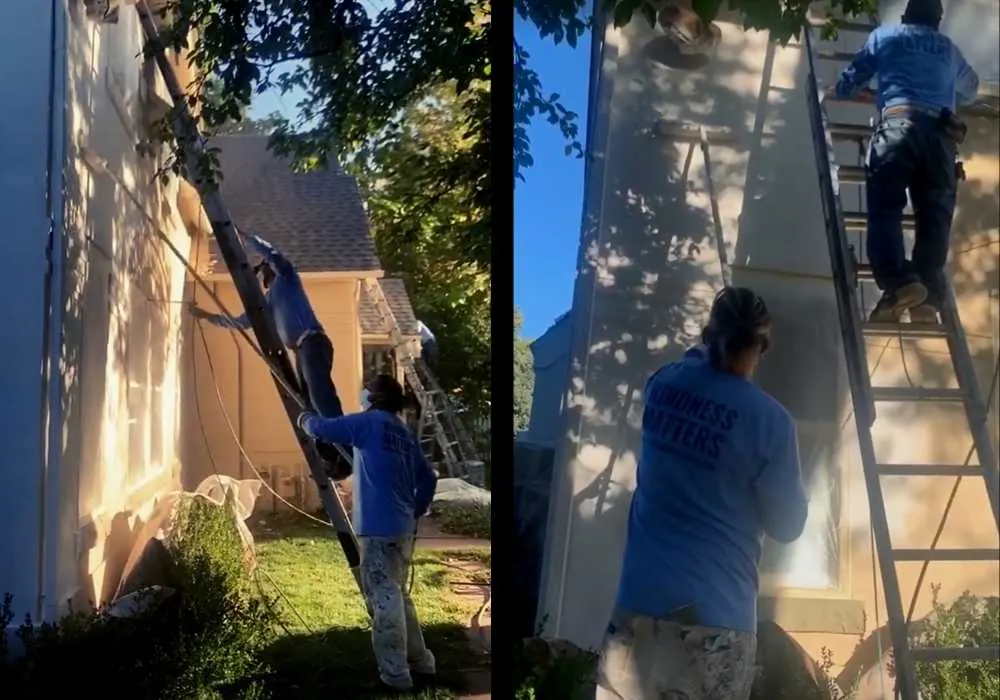 Two painters working on a stucco exterior, one spraying and one back-rolling the paint in